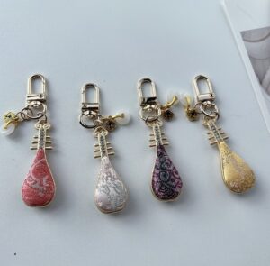 Set of 4 pipa‑shaped keychains, Chinese traditional silk fabric bag charm souvenir gift