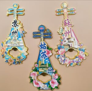 Suzhou Gusu pipa‑shaped metal fridge magnet and bottle opener, decorated with Jiangnan folk houses, butterfly and floral motifs, Chinese‑style cultural travel souvenir