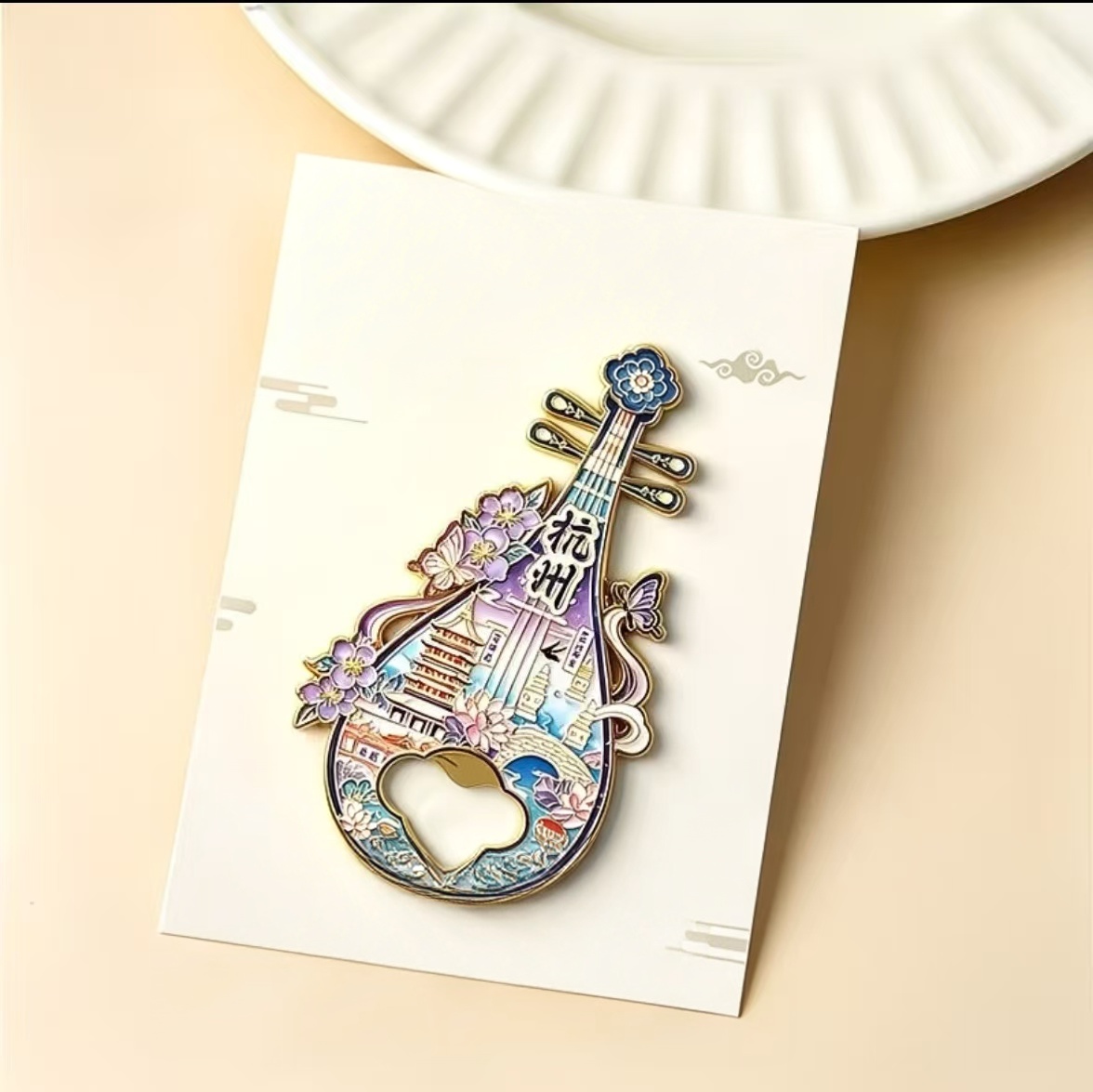 Metal bottle opener refrigerator magnet in pipa shape, decorated with scenery patterns of Hangzhou West Lake, Leifeng Pagoda, Broken Bridge and other iconic attractions. Ideal tourist souvenir and traditional Chinese cultural gift.
